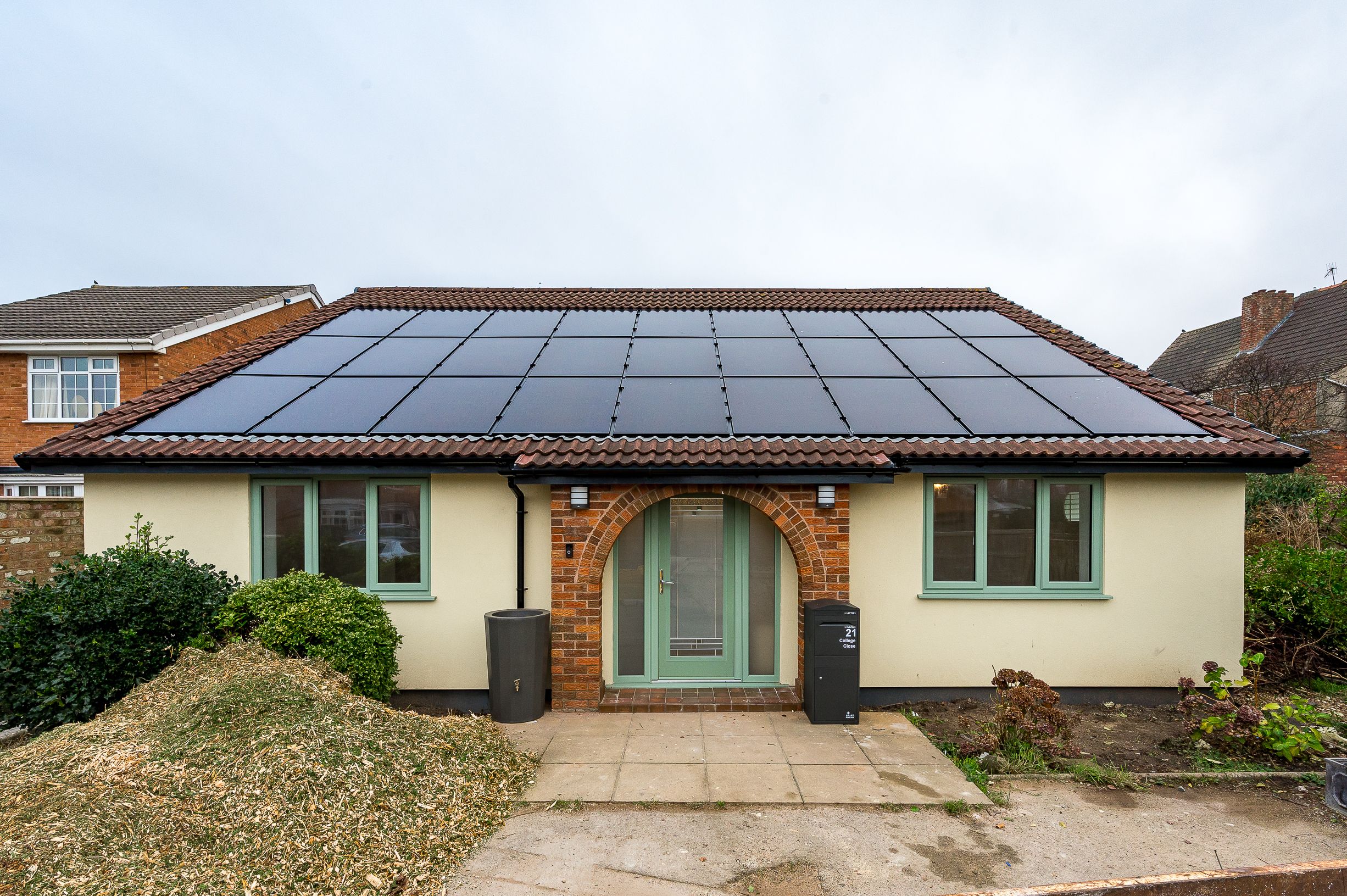 A retrofitted bungalow from the front of the house showing their built in solar panels