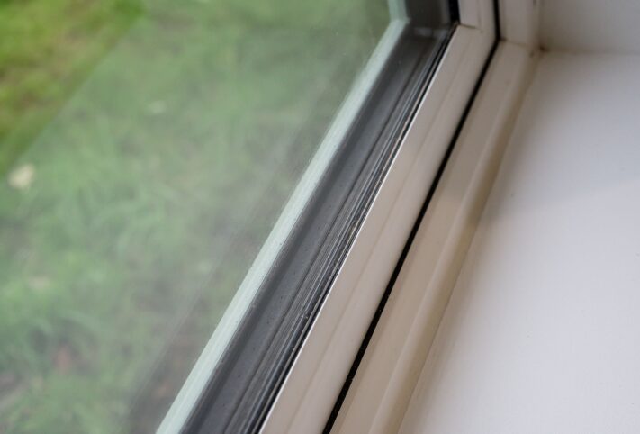 a close up image of a window showing triple glazing in a retrofitted bungalow